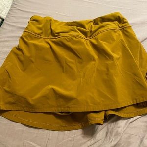 Mustard play off the pleats Lulu tennis skirt